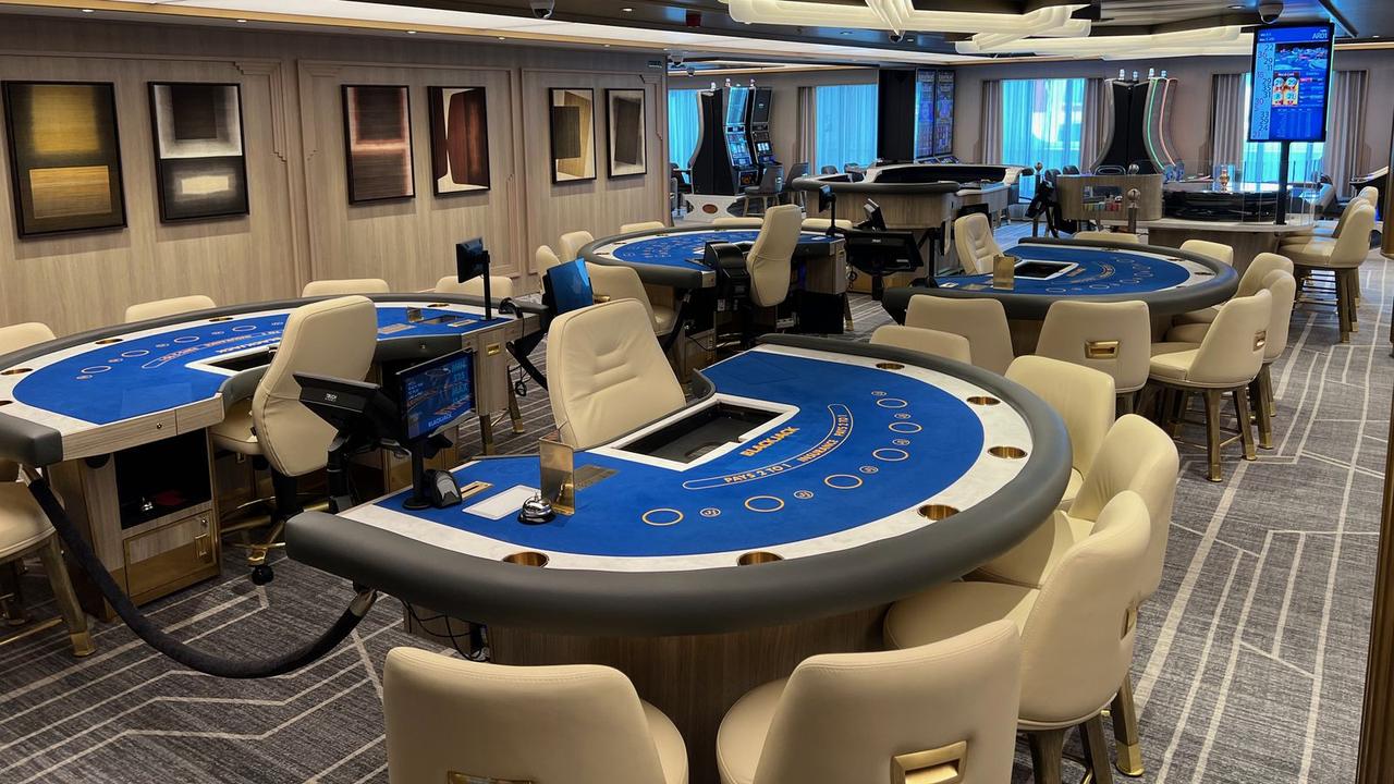 Card tables and slot terminals in the casino of a cruise ship