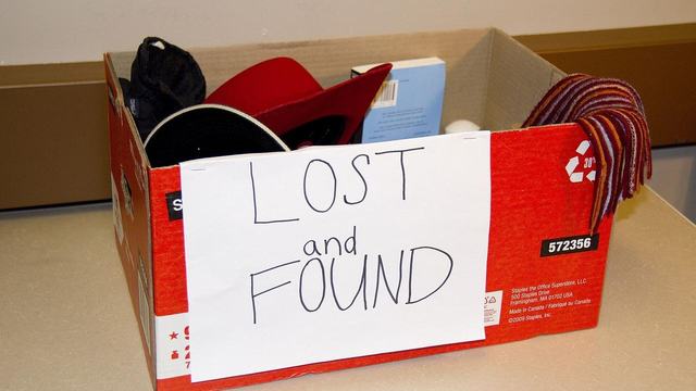 A cardboard lost and found box full of forgotten belongings